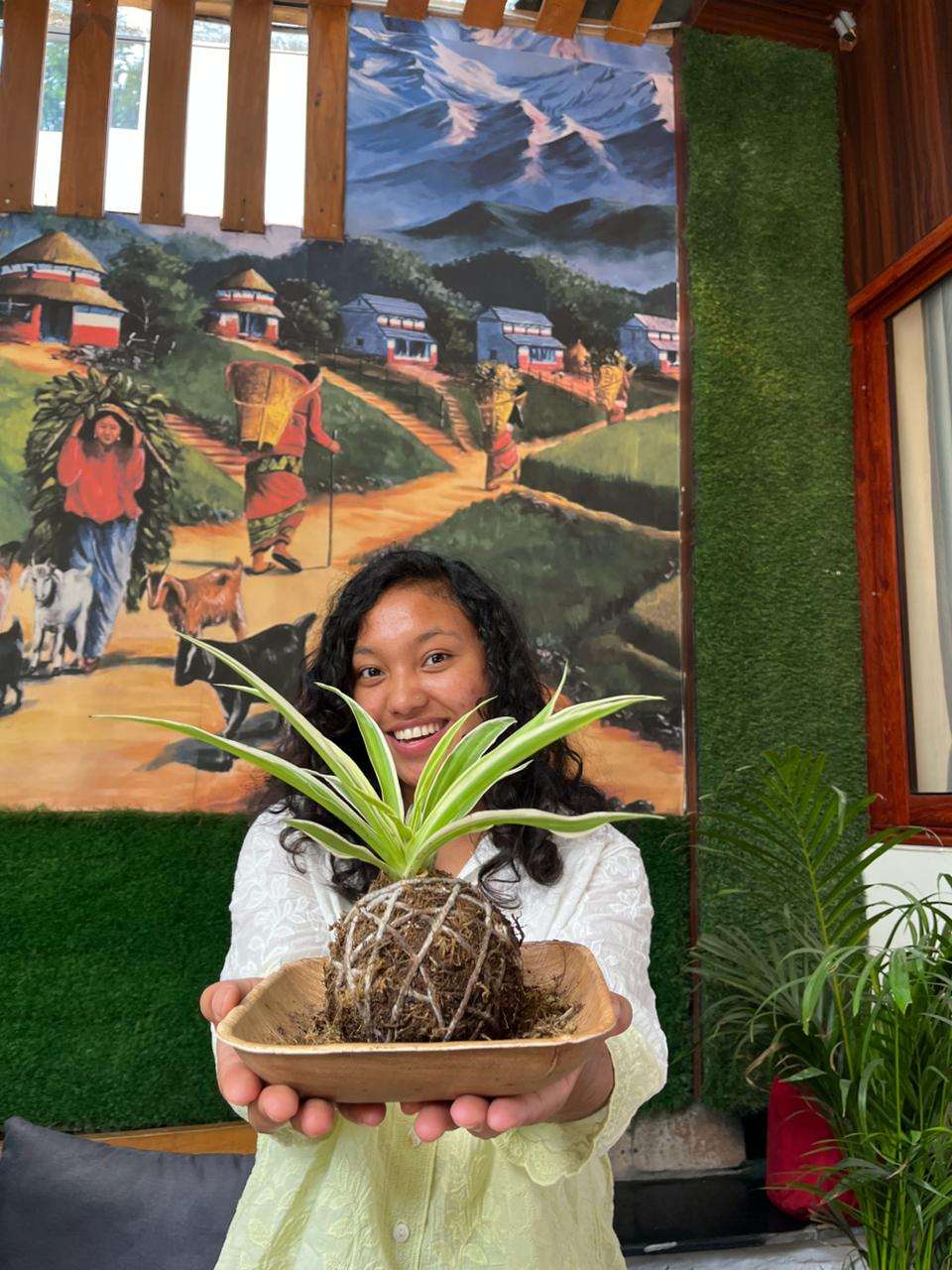Participant shaping plant art during workshop